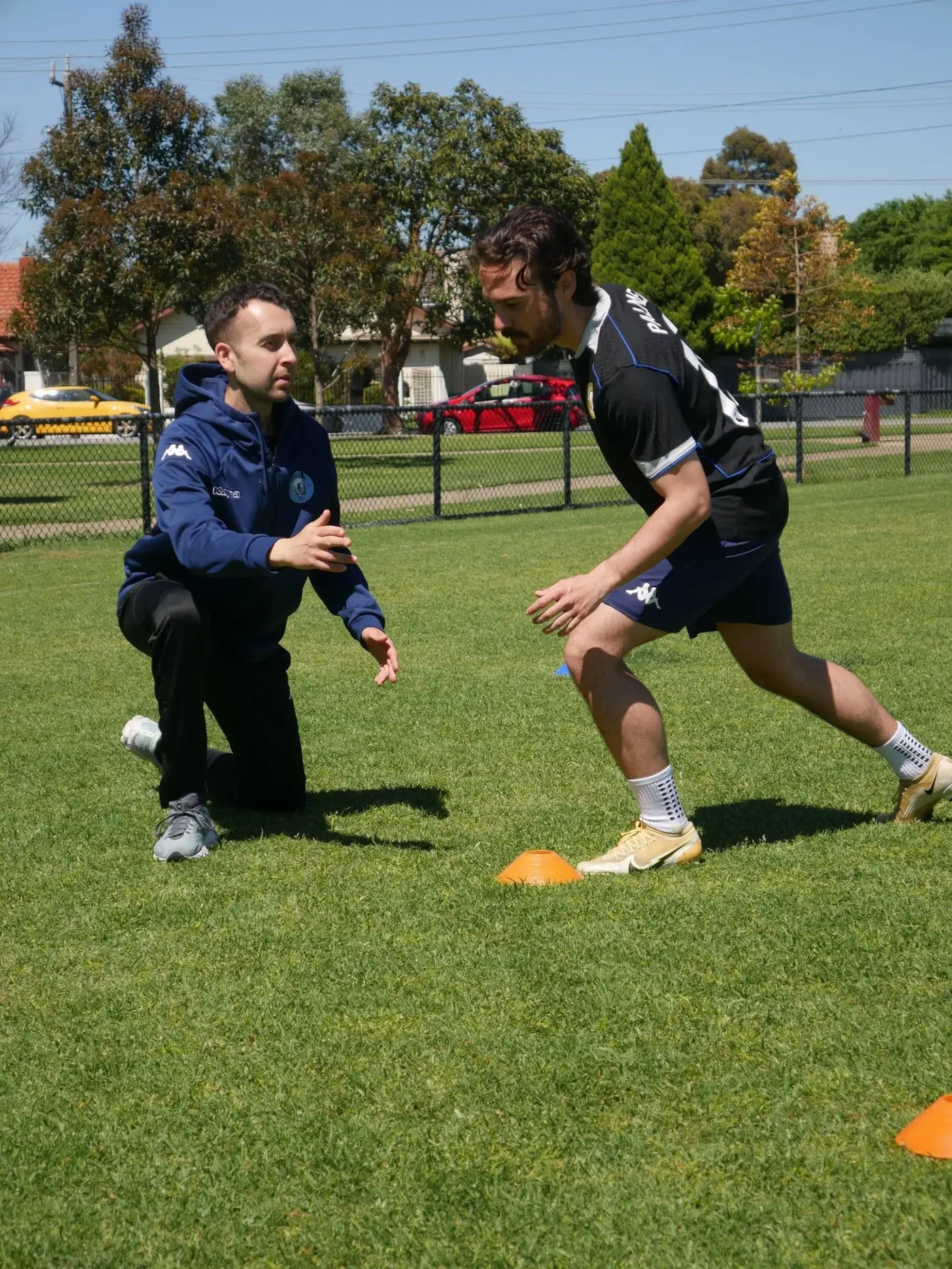 Jake coaching a footballer through a change-of-direction drill around cones