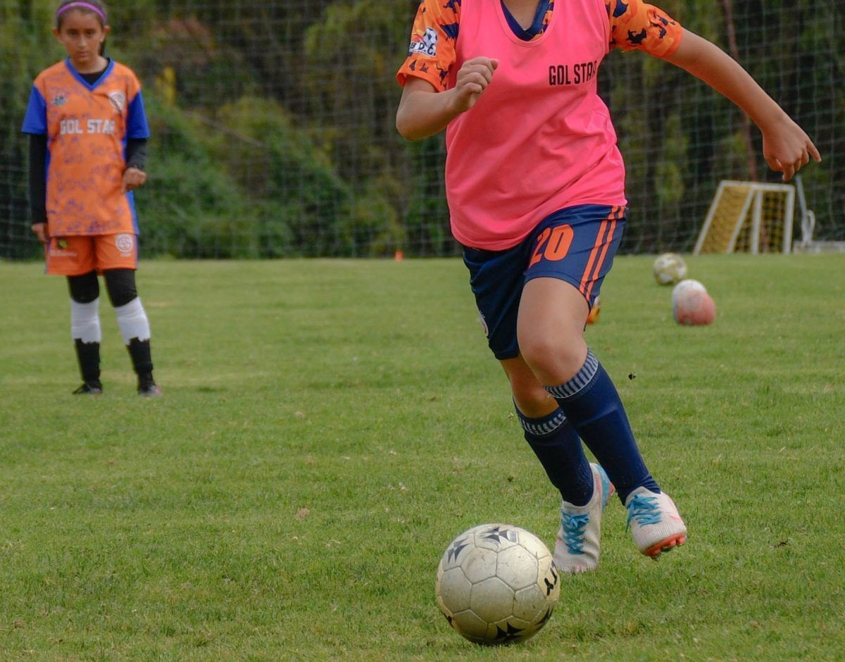 Junior footballer training with a coach