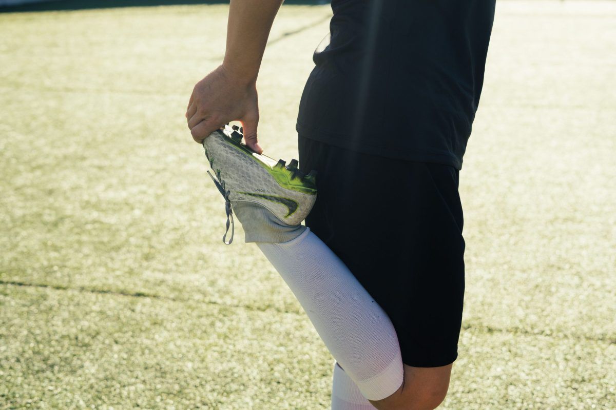 Football player sprinting at full speed on a grass pitch